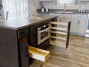 Full-extension pullout drawers and a pullout spice rack in base cabinets.