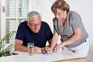 An older couple looking at brochures.